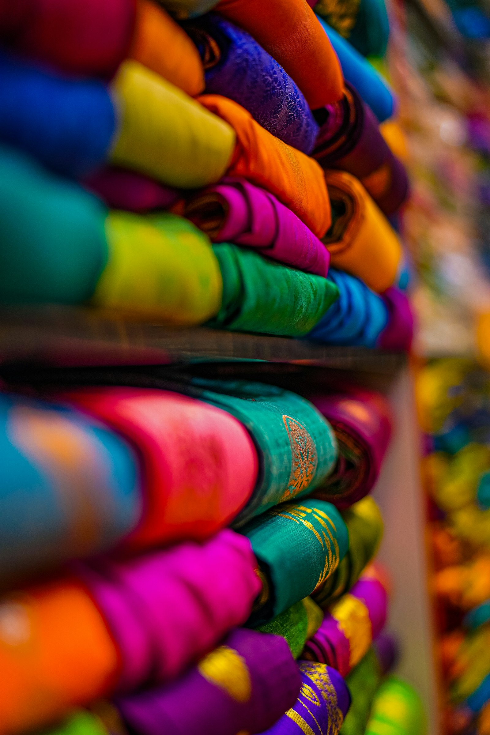 Folded sarees stacked at Trending Wholesale Sarees